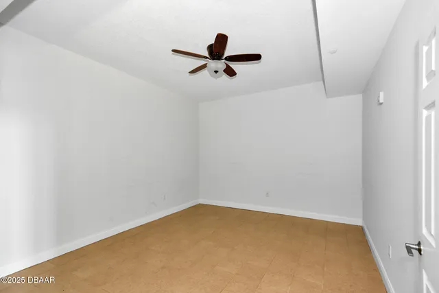a view of room with window and wooden floor