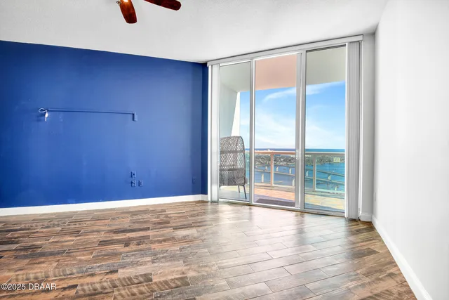 a living room with furniture a flat screen tv and a large window