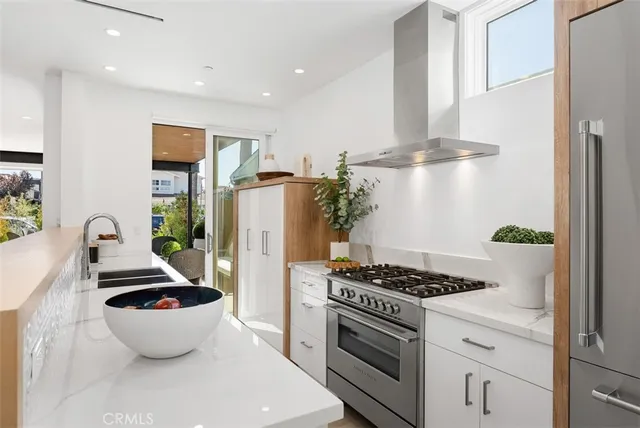 a kitchen with stainless steel appliances a white stove top oven and a refrigerator