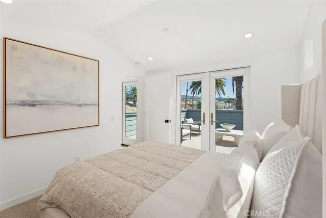 a bedroom with a large bed and a painting on the wall