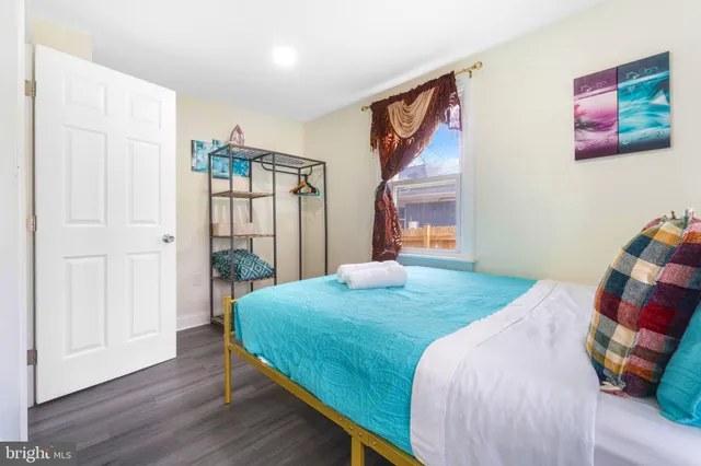 a bedroom with a bed and a painting on the wall