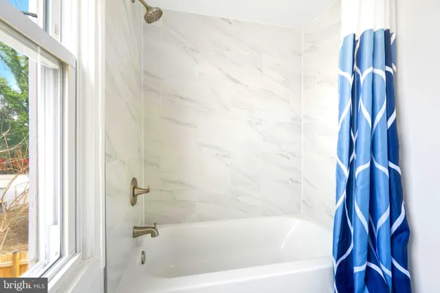 a bathroom with a bathtub and a shower