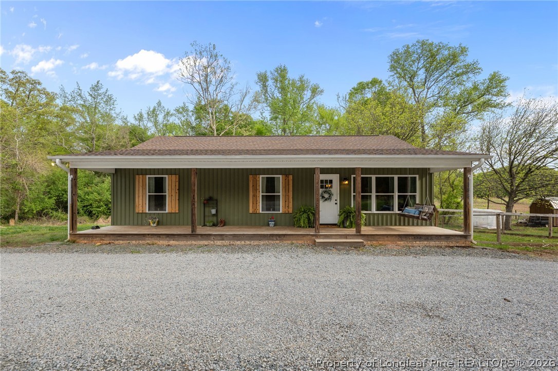 186 Lewis Brown Road Bennett, NC 27208 - Photo 2 of 48 front view of a house with a garden