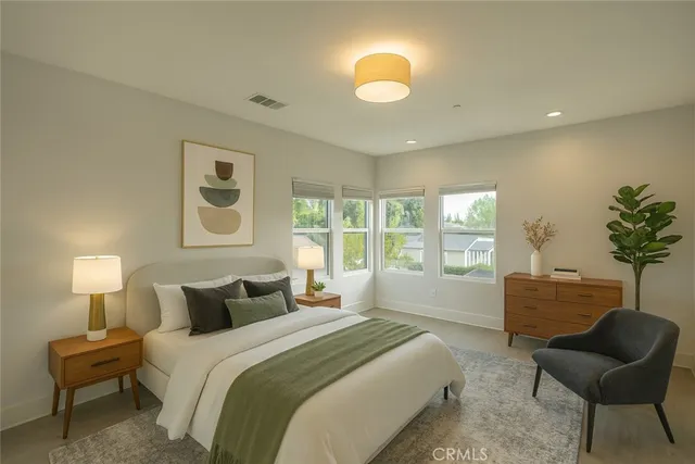 a bedroom with a bed and chair