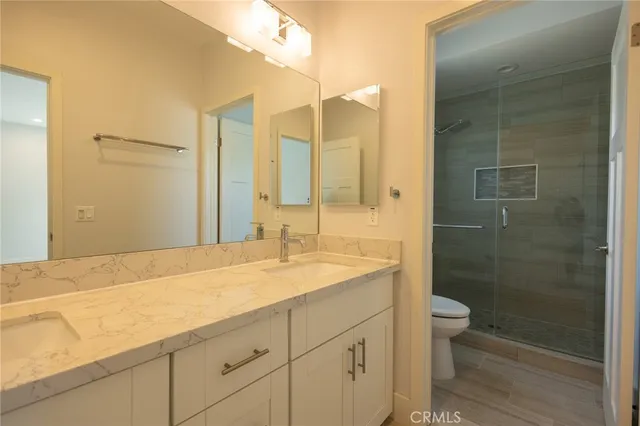 a bedroom with a bed and painting on the wall