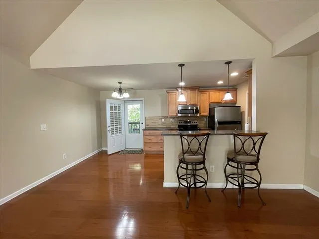 a kitchen with a stove and a refrigerator