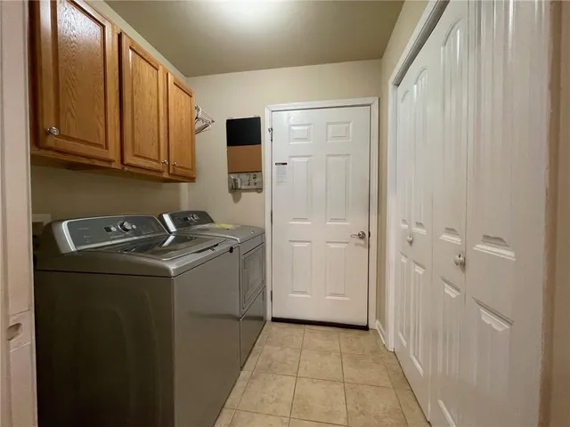 a spacious bedroom with a bed and a night stand