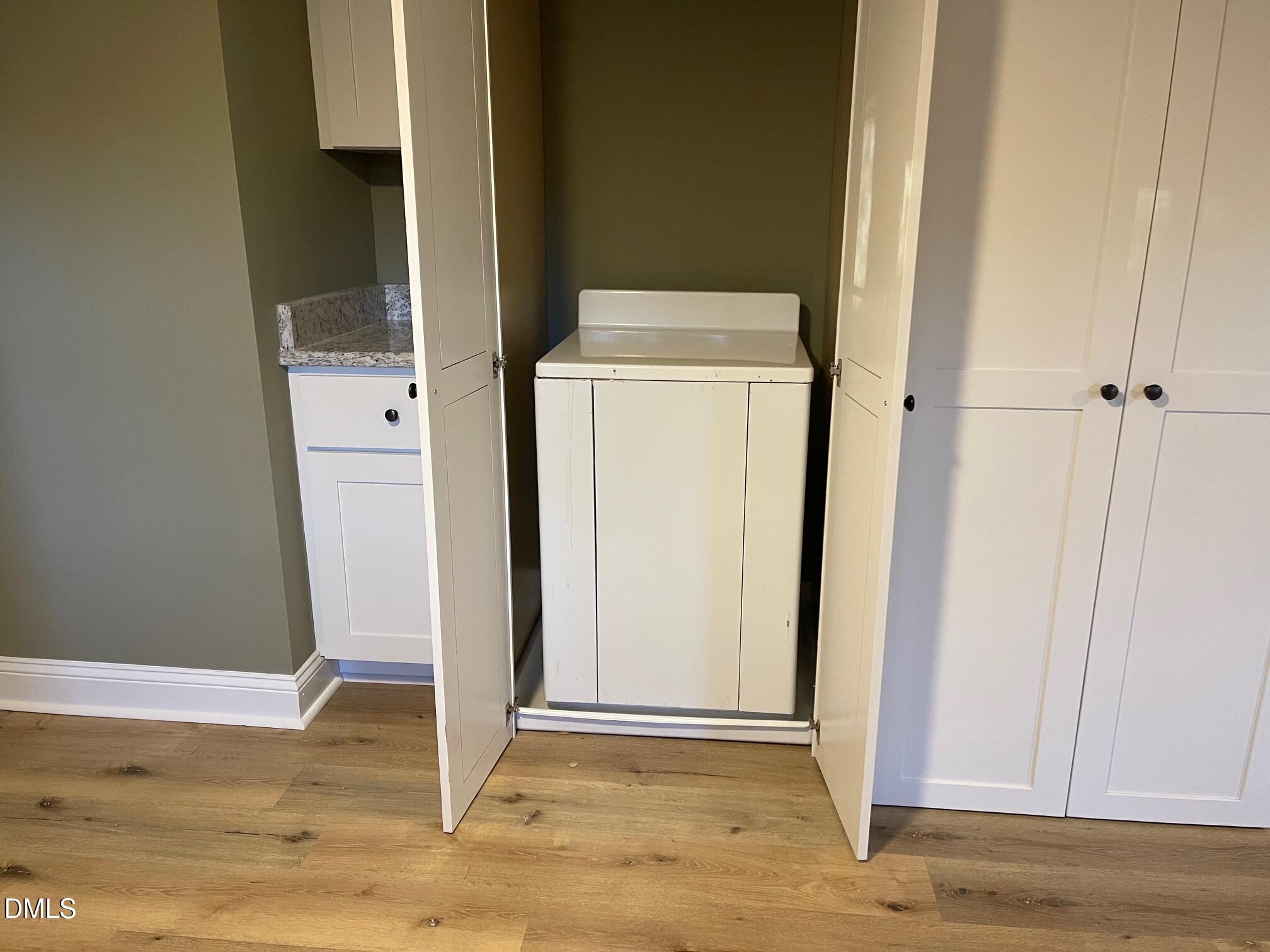 409 Lipscomb Road Angier, NC 27501 - Photo 13 of 29 a view of storage and utility room with wooden floor