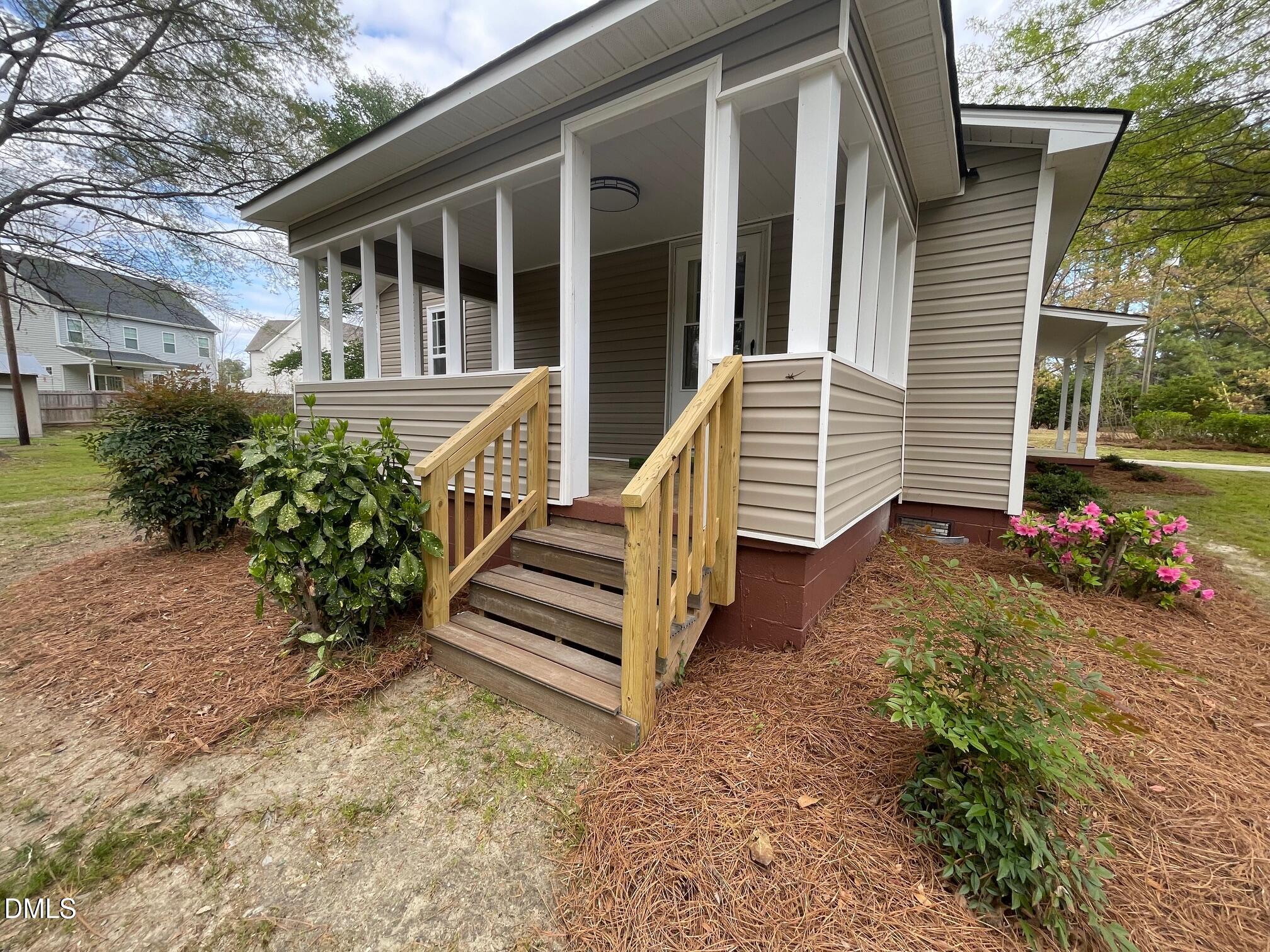 409 Lipscomb Road Angier, NC 27501 - Photo 4 of 29 a view of a house with backyard and a garden