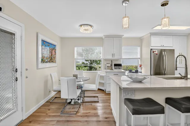a view of kitchen with sink dining table and chairs