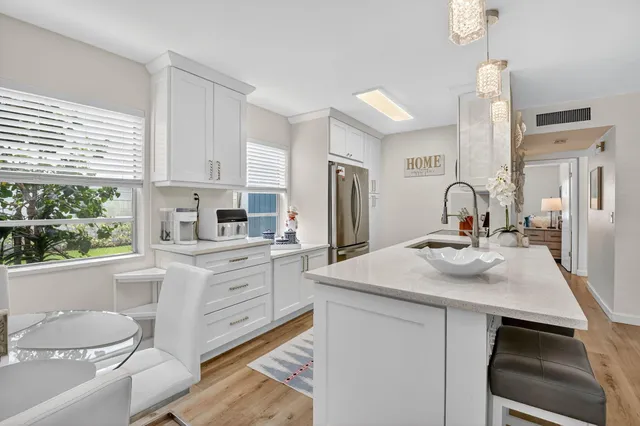 a kitchen with a sink stove and refrigerator