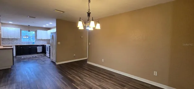 a view of a kitchen with a sink and wooden floor