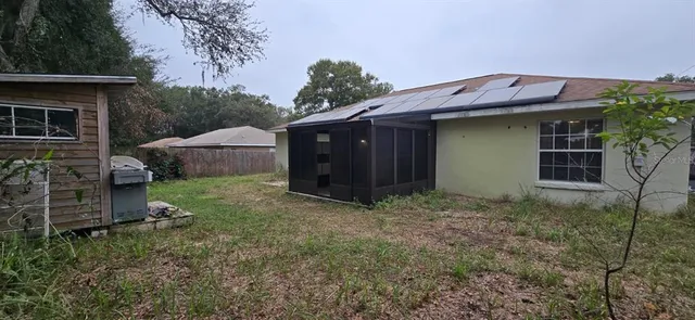 a view of a house with a yard and plants