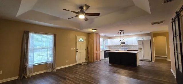 a view of kitchen with sink and wooden floor