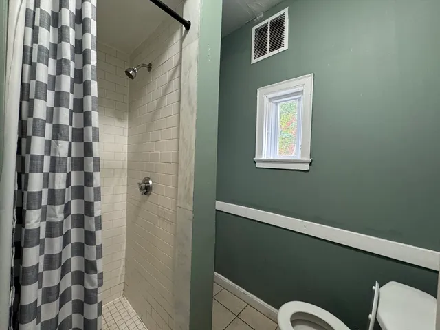 a bathroom with a bathtub and shower