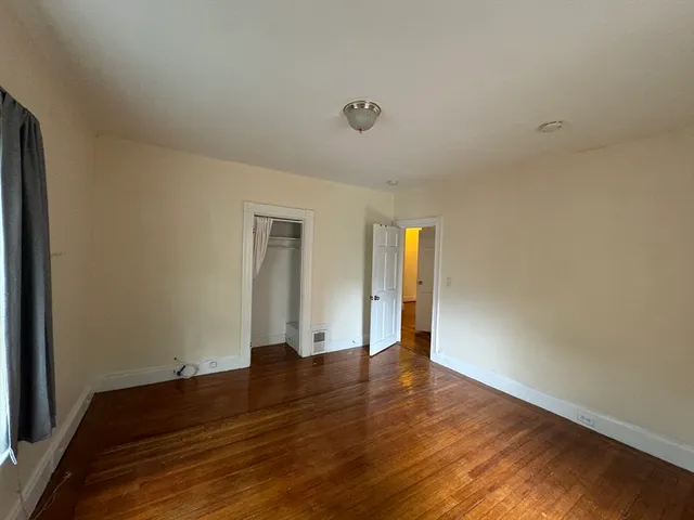 a view of an empty room and wooden floor