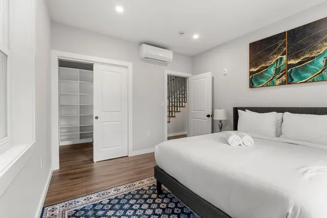 a bedroom with a bed and a walk in closet