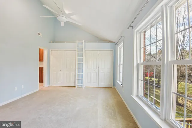 an empty room with windows and entrance