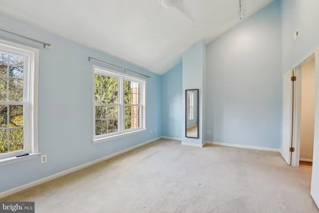 an empty room with windows and closet
