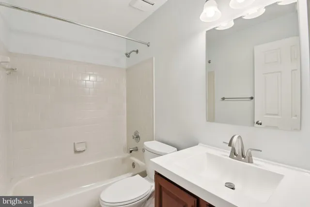 a bathroom with a sink toilet tub and shower