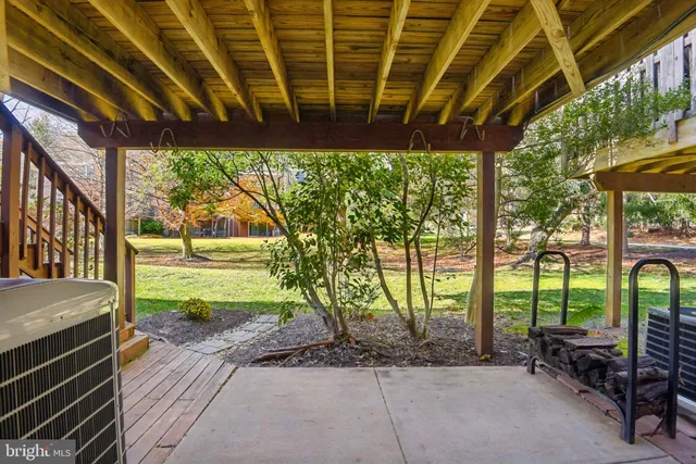 a view of a porch with furniture and a yard