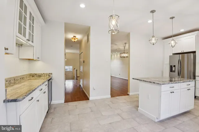 a kitchen with a sink and refrigerator