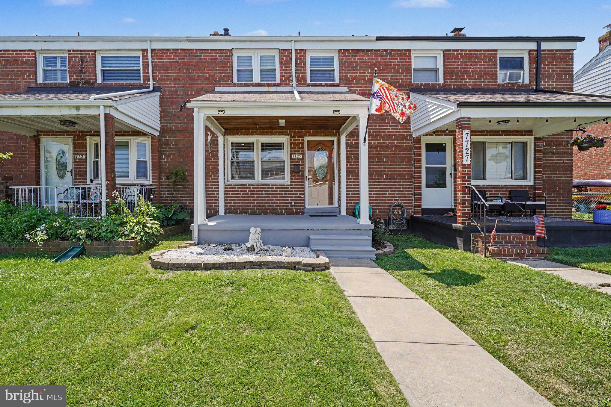 7729 Charlesmont Road Baltimore, MD 21222 - Photo 2 of 43 front view of a brick house with a yard