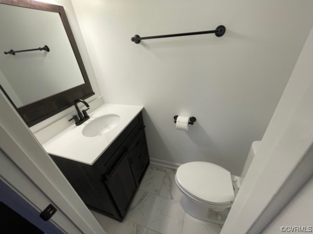 2139 Coxendale Road Chester, VA 23831 - Photo 6 of 15 a bathroom with a sink a toilet a mirror and vanity