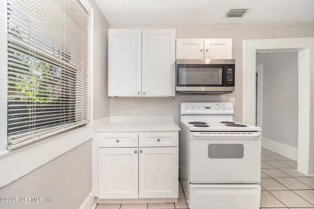 a kitchen with a stove and a microwave
