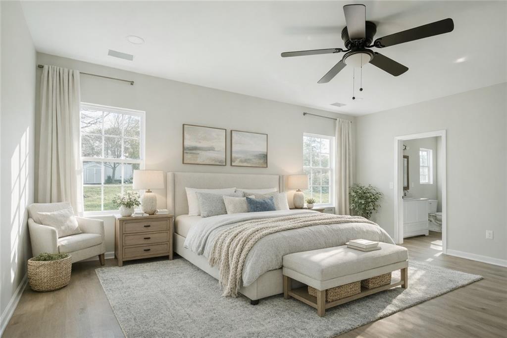 112 Neal Avenue Stockbridge, GA 30281 - Photo 11 of 19 a bedroom with a bed a couch and a chandelier fan