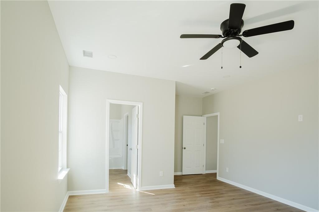 112 Neal Avenue Stockbridge, GA 30281 - Photo 12 of 19 a view of a room with a window and wooden floor