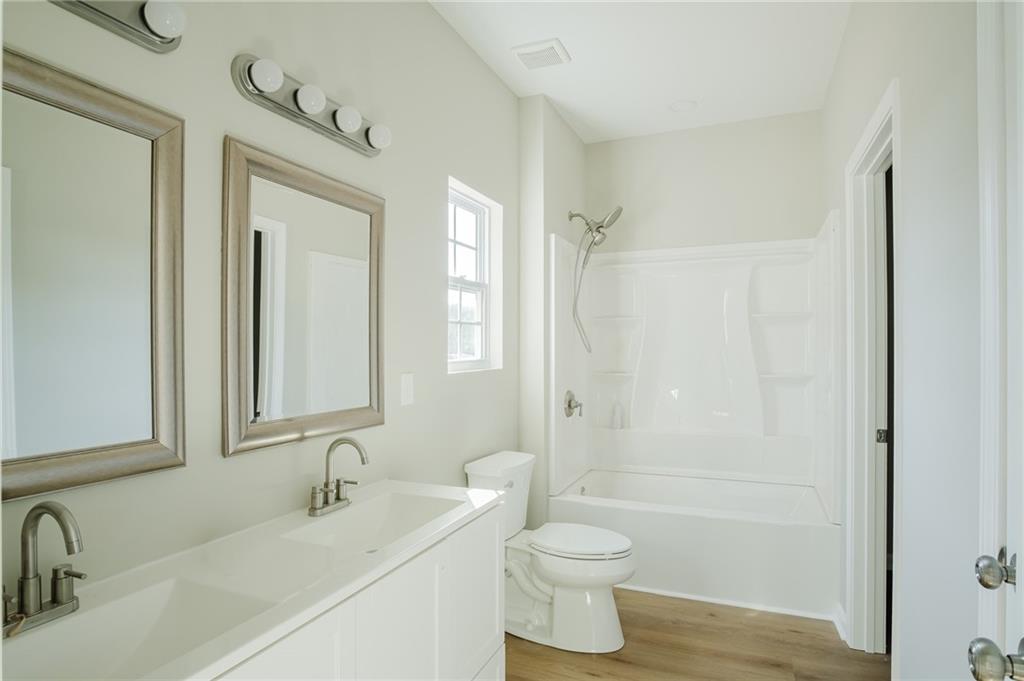 112 Neal Avenue Stockbridge, GA 30281 - Photo 13 of 19 a bathroom with a sink a toilet and shower