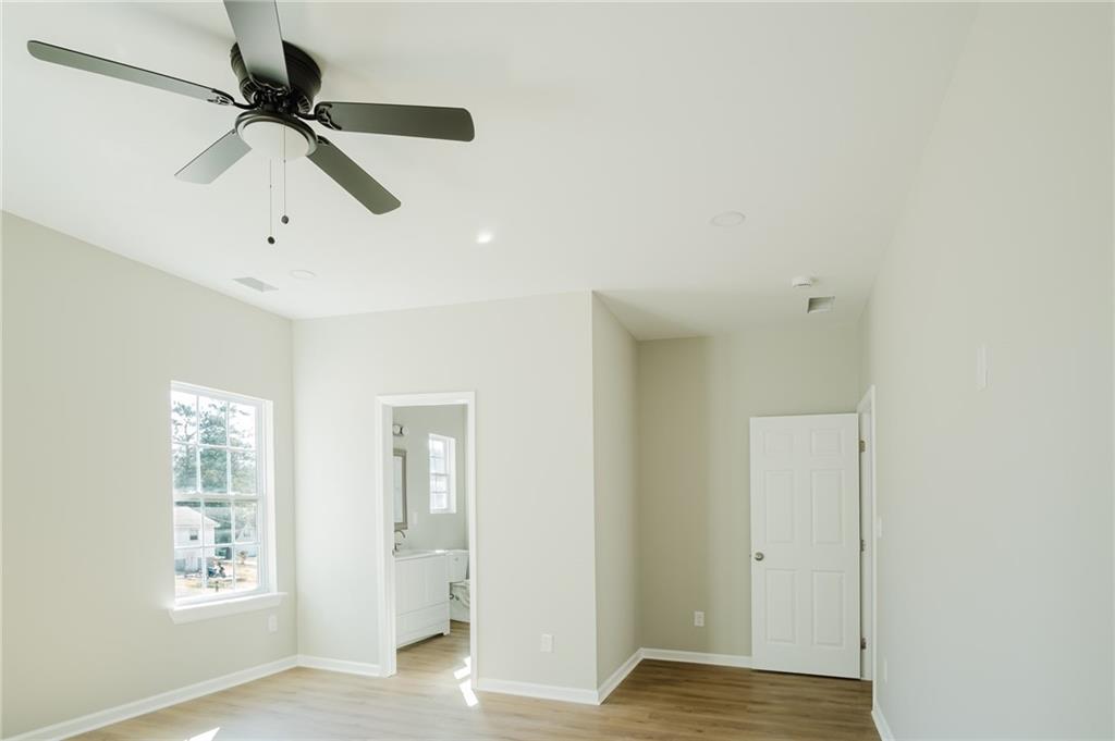 112 Neal Avenue Stockbridge, GA 30281 - Photo 14 of 19 a view of an empty room with window and wooden floor