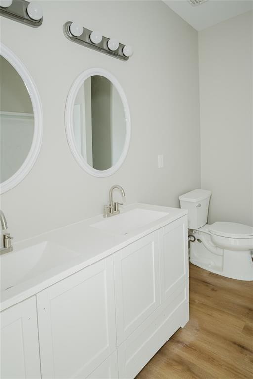 112 Neal Avenue Stockbridge, GA 30281 - Photo 15 of 19 a bathroom with a toilet sink and mirror