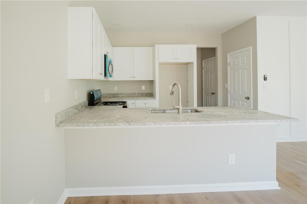 112 Neal Avenue Stockbridge, GA 30281 - Photo 3 of 19 a bathroom with a sink and a mirror