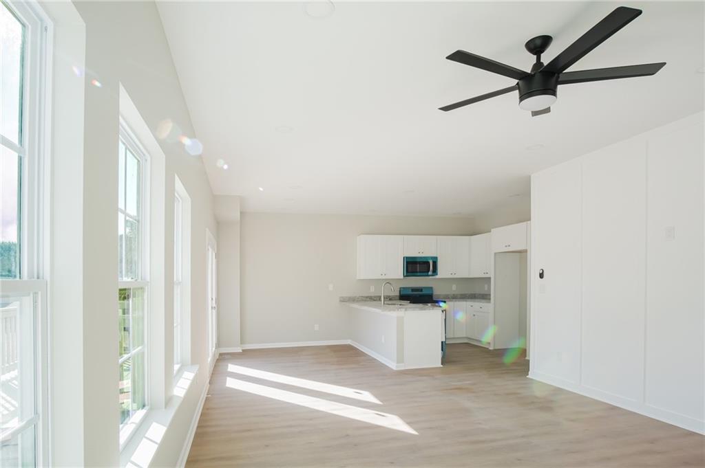 112 Neal Avenue Stockbridge, GA 30281 - Photo 4 of 19 a kitchen with white cabinets and white appliances