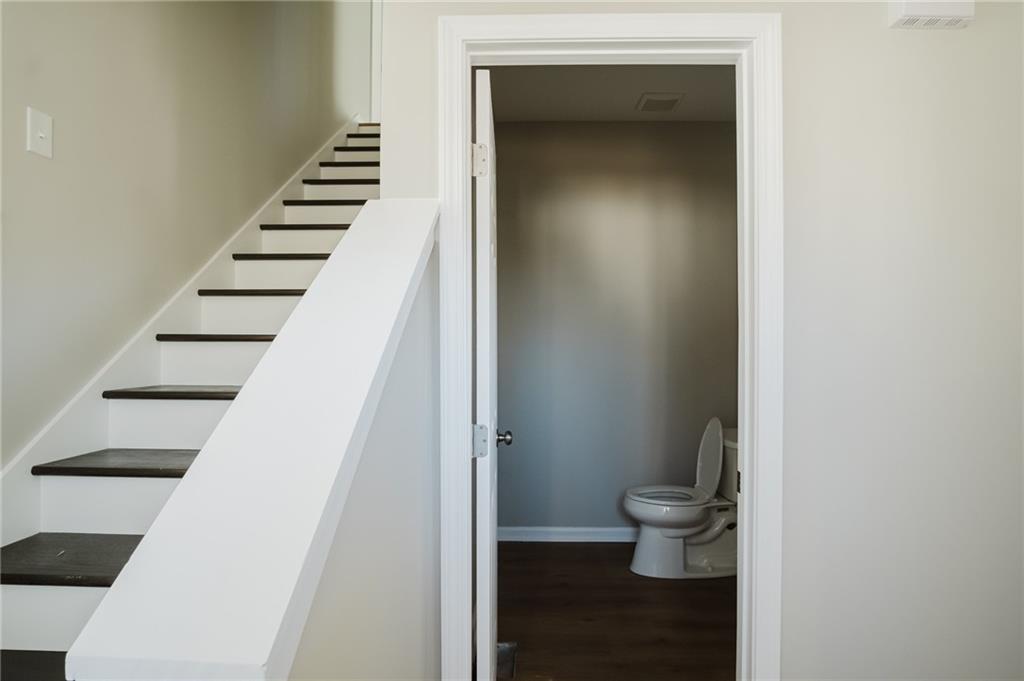 112 Neal Avenue Stockbridge, GA 30281 - Photo 6 of 19 a view of a hallway with wooden floor and stairs