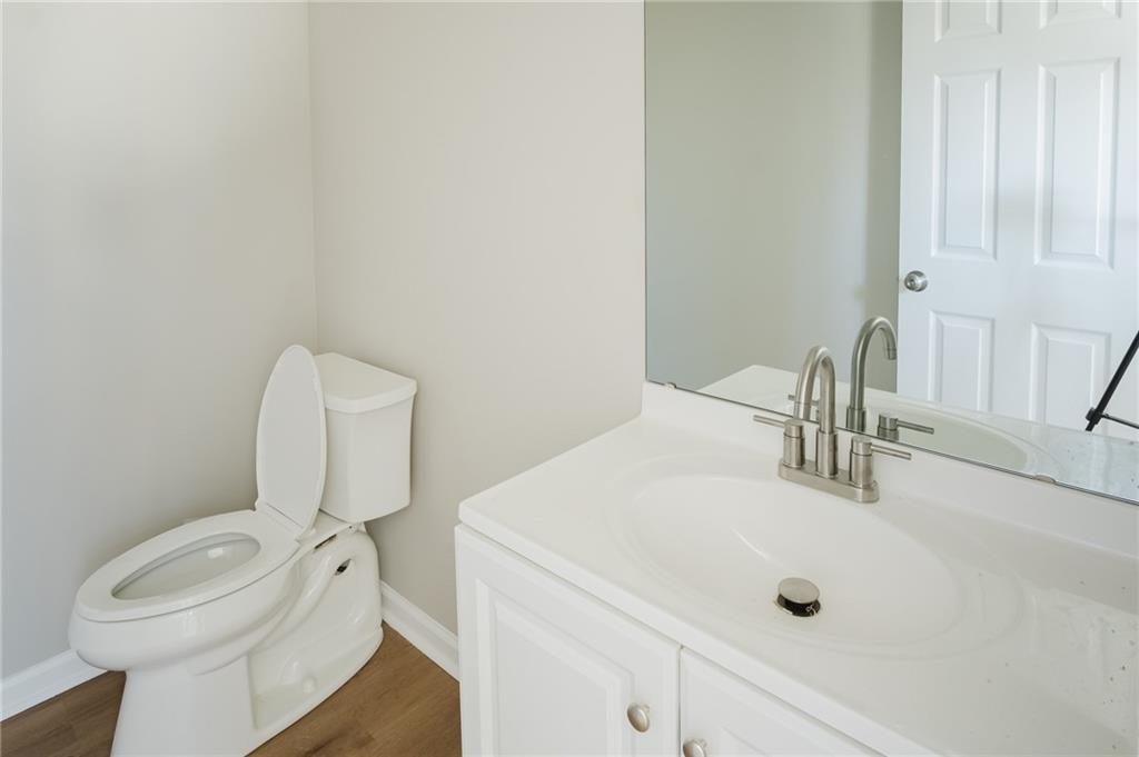 112 Neal Avenue Stockbridge, GA 30281 - Photo 7 of 19 a bathroom with a sink a toilet and mirror