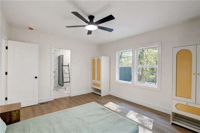 a view of a livingroom with a window and wooden floor
