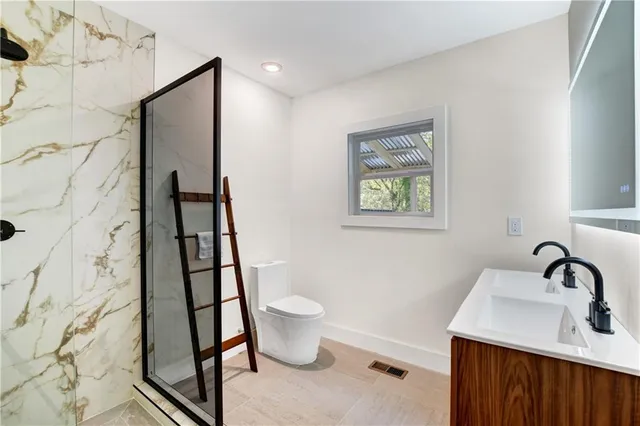 a bathroom with a sink toilet and shower