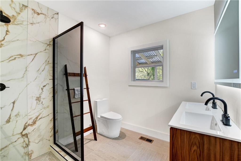 458 Shannon Drive Southwest Atlanta, GA 30310 - Photo 14 of 28 a bathroom with a sink toilet and shower