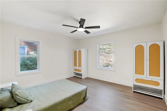 a bedroom with a bed and a large window