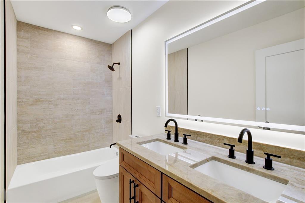 458 Shannon Drive Southwest Atlanta, GA 30310 - Photo 16 of 28 a bathroom with a granite countertop sink a toilet and bathtub