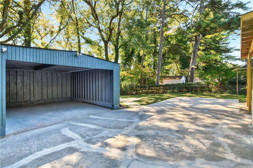 458 Shannon Drive Southwest Atlanta, GA 30310 - Photo 24 of 28 a view of a backyard with large trees and wooden fence