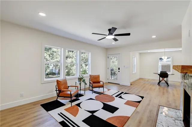 a living room with furniture and wooden floor