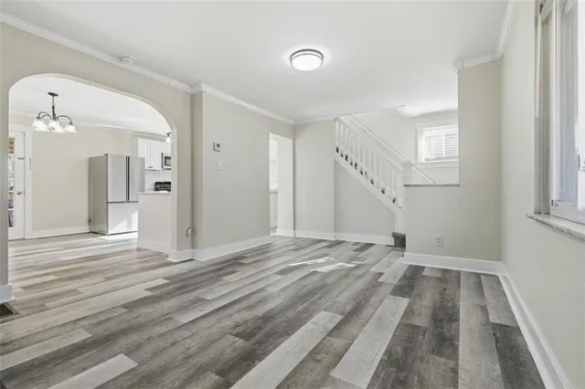 a view of a livingroom with wooden floor and stairs