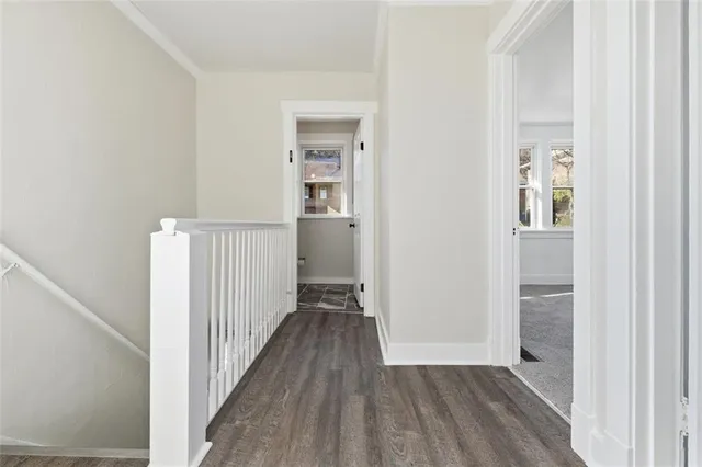 a view of a hallway with wooden floor and entryway