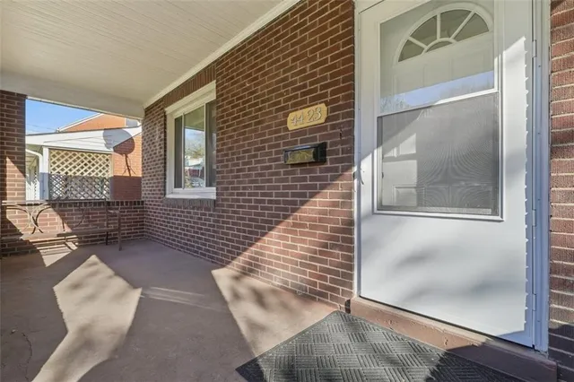 a view of a patio with wooden floor and a door