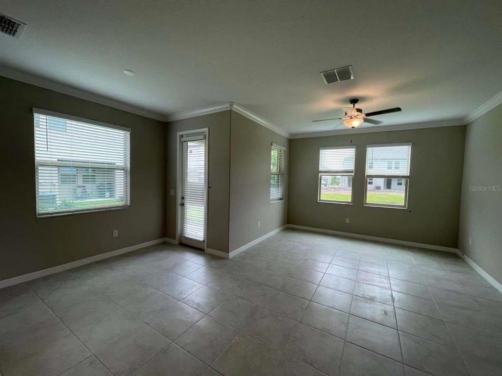 31993 Blue Passing Loop Wesley Chapel, FL 33545 - Photo 9 of 17 a view of an empty room with a window