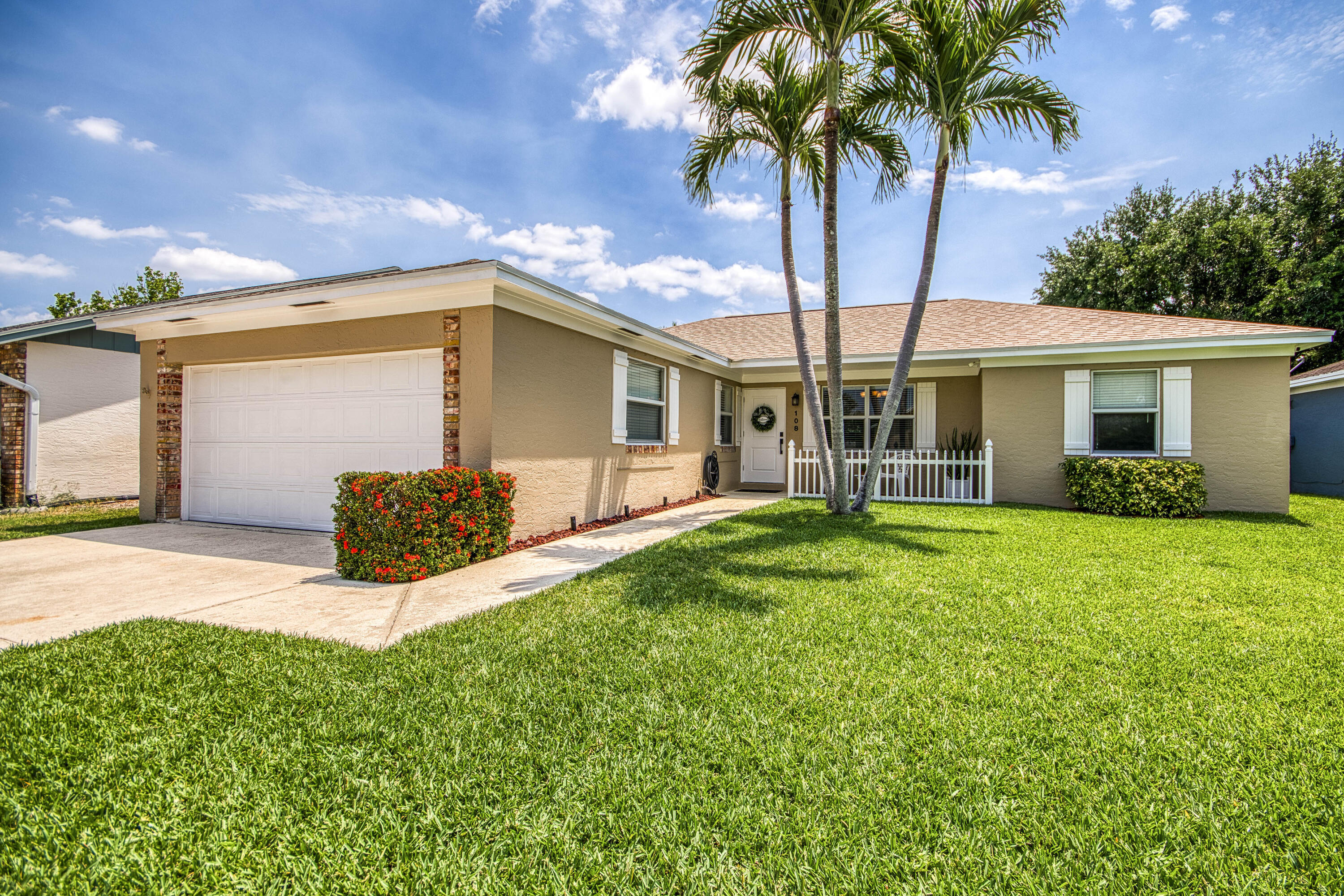 108 Wandering Trail Jupiter, FL 33458 - Photo 3 of 34 a view of a house with backyard and a tree